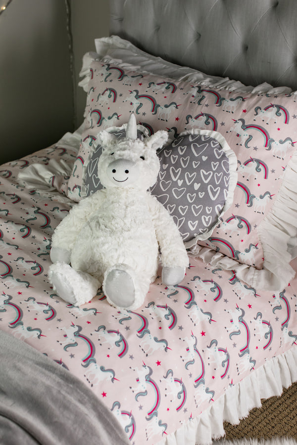 picture of pink unicorn fabric on girls bed
