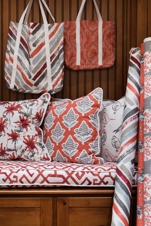 photo of chinese fabrics on pillows on a bench in a modern mud room