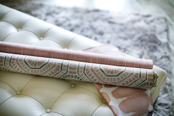 Photo of white and pink fabric on modern white leather bench