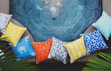 picture of pillows made with outdoor pool beach summer fabric sitting beside hot tub
