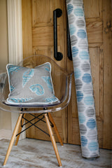 photo of nautical themed fabric pillow sitting in modern art chair