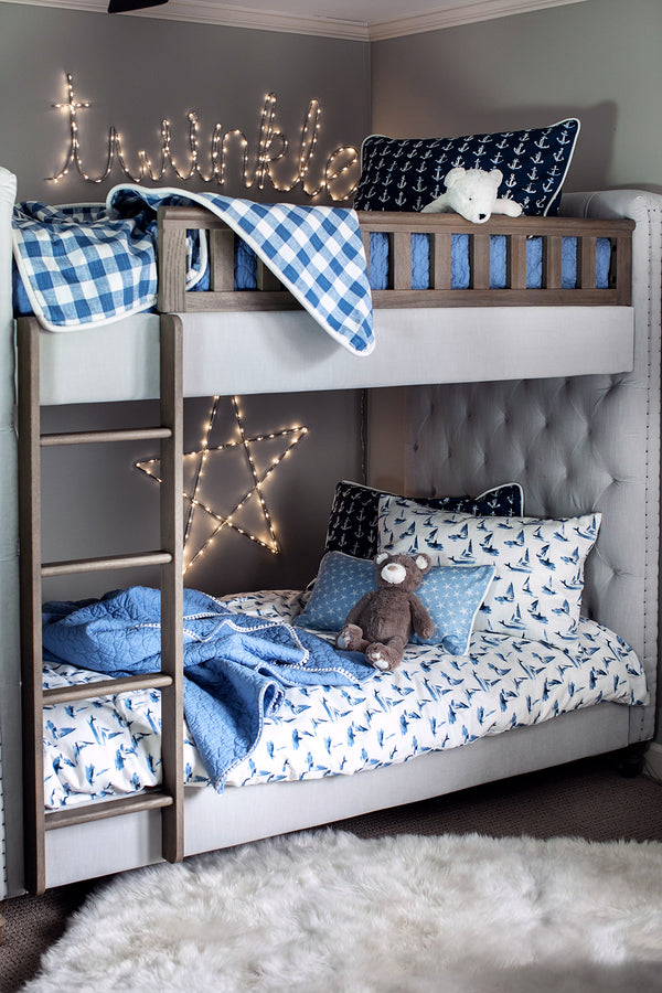 picture of children's nautical themed fabric in a child's bedroom with sailboats and ship anchors plaid