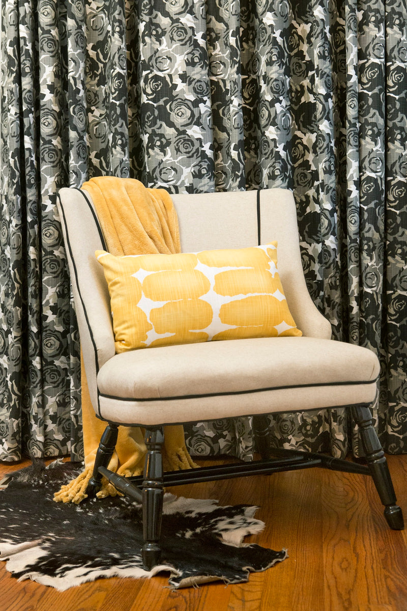 photo of black grey curtains with a yellow pillow made with classic styled fabric
