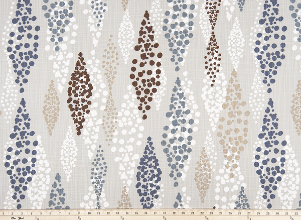 Photo of blue, brown, beige, and white repeating diamond pattern on tan colored fabric