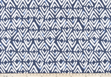 photo of white diamond pattern on blue fabric