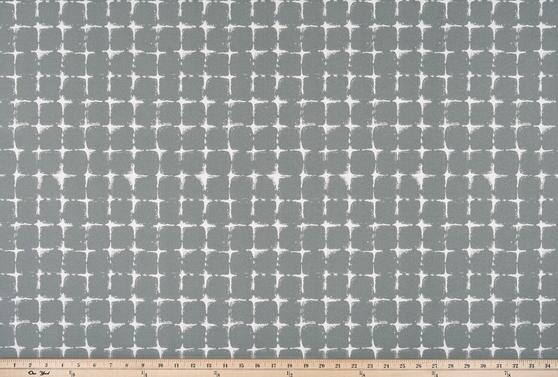 photo of repeating square geometric pattern printed fabric perfect for the beach