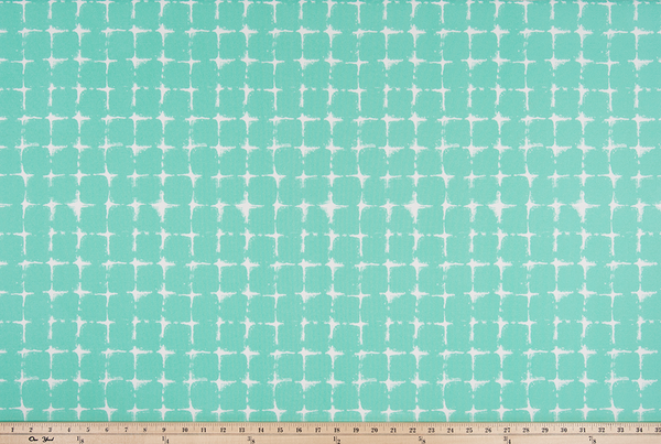 photo of repeating square geometric pattern printed fabric perfect for the beach