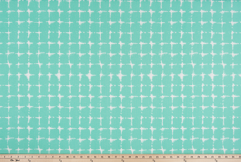 photo of repeating square geometric pattern printed fabric perfect for the beach