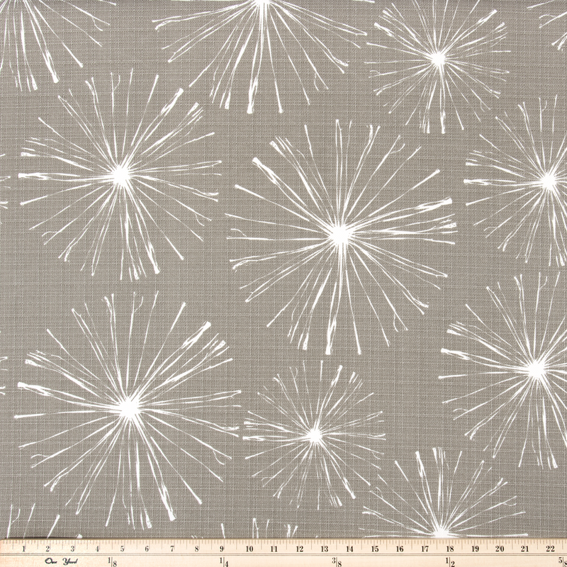 photo of white starburst firework pattern printed on beige fabric sparkle flare