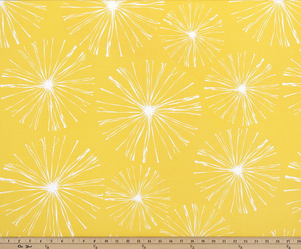 photo of white starburst firework pattern printed on yellow fabric sparkle flare