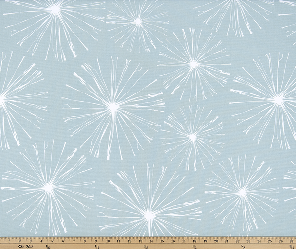 photo of white starburst firework pattern printed on blue fabric sparkle flare