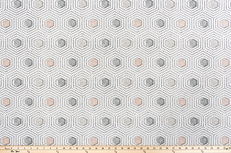 Photo of grey and pink repeating dotted pattern fabric