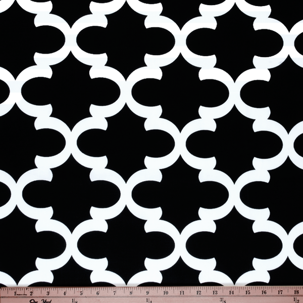 Photo of black Quatrefoil trellis pattern printed on white fabric
